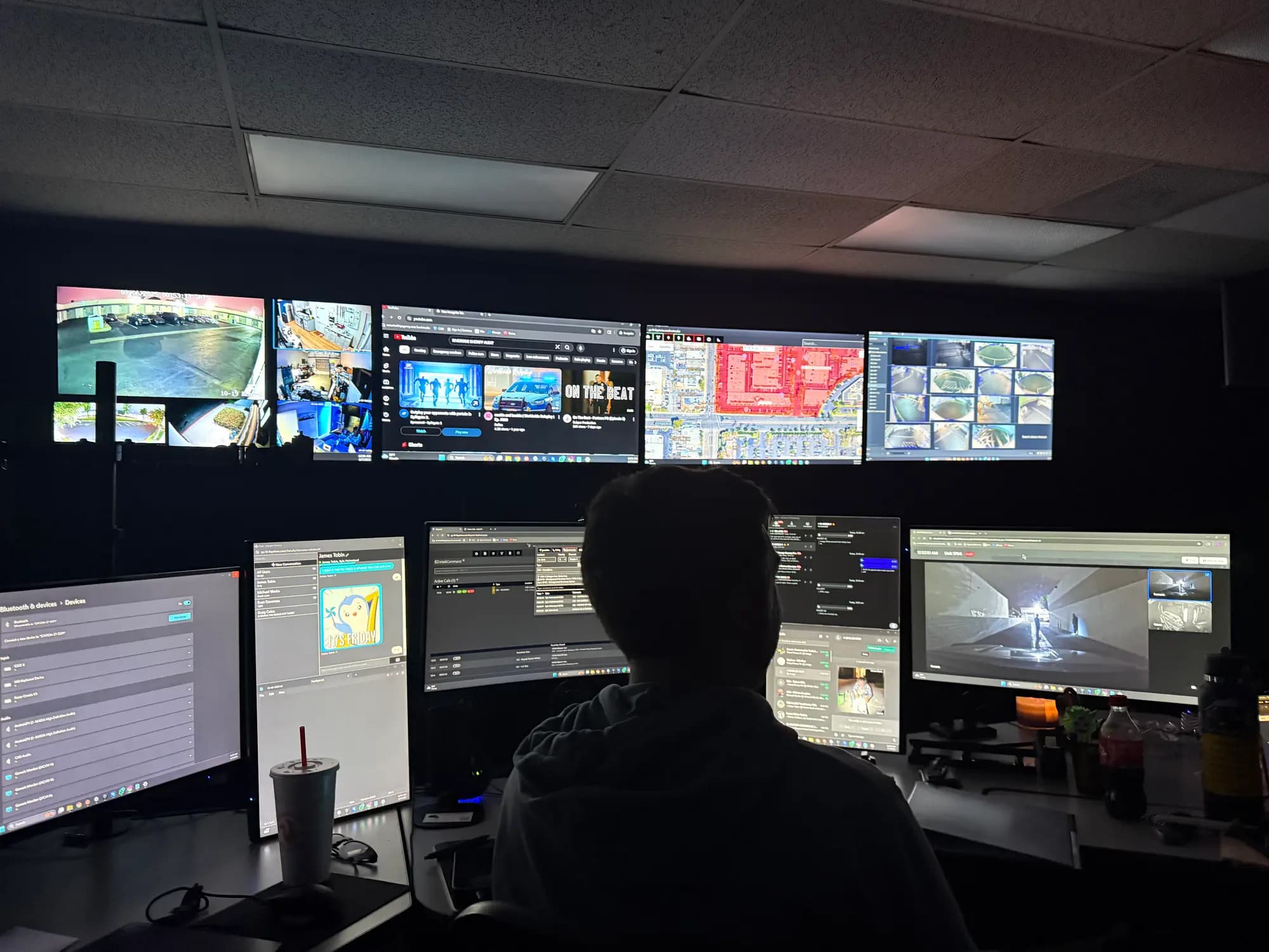 24/7 dispatch command center with live monitor wall, slow ambient pan