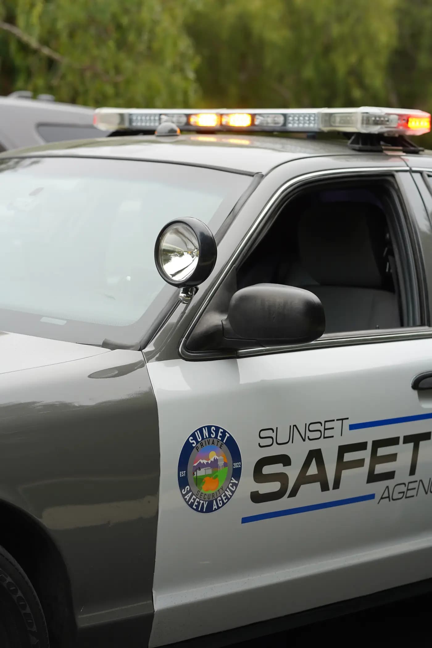 Patrol SUV door with the round agency seal, spotlight, and amber lightbar