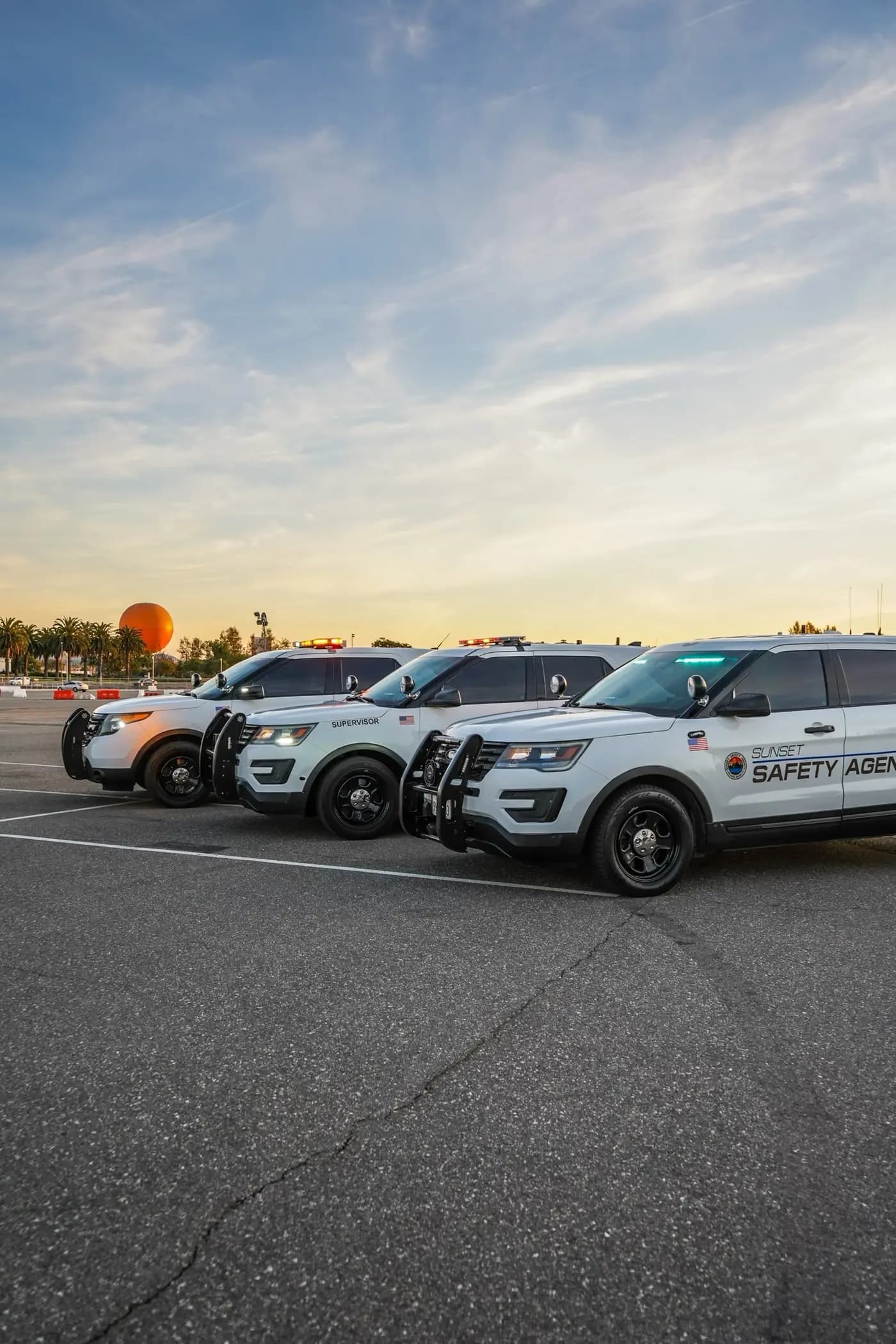 Vertical view of the three-unit patrol fleet at dusk with lightbars lit