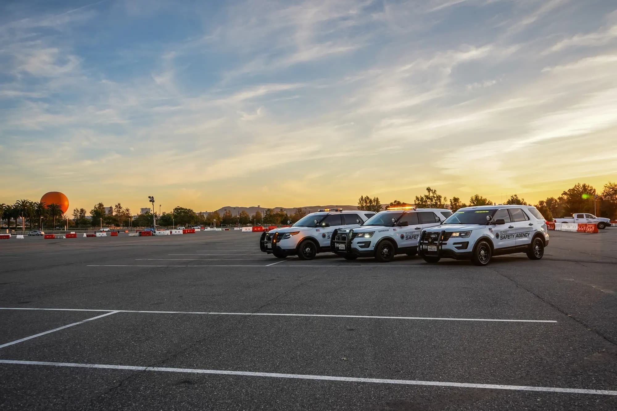 Patrol fleet lined up at sunset with the Orange County Great Park balloon on the horizon