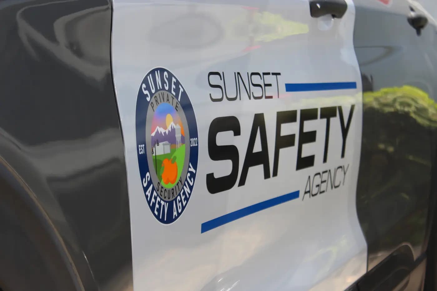 Extreme close-up of the Sunset Safety Agency door lettering and Private Security seal