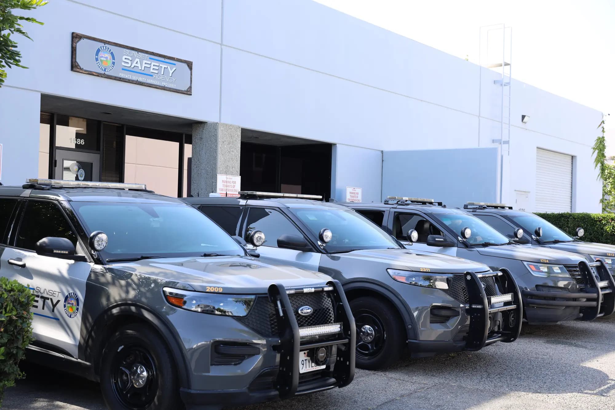 Four marked patrol SUVs parked in a row at the headquarters storefront