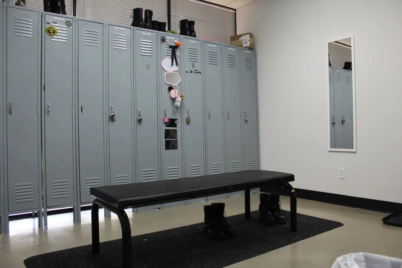 Officer locker room with polished duty boots lined up on a bench