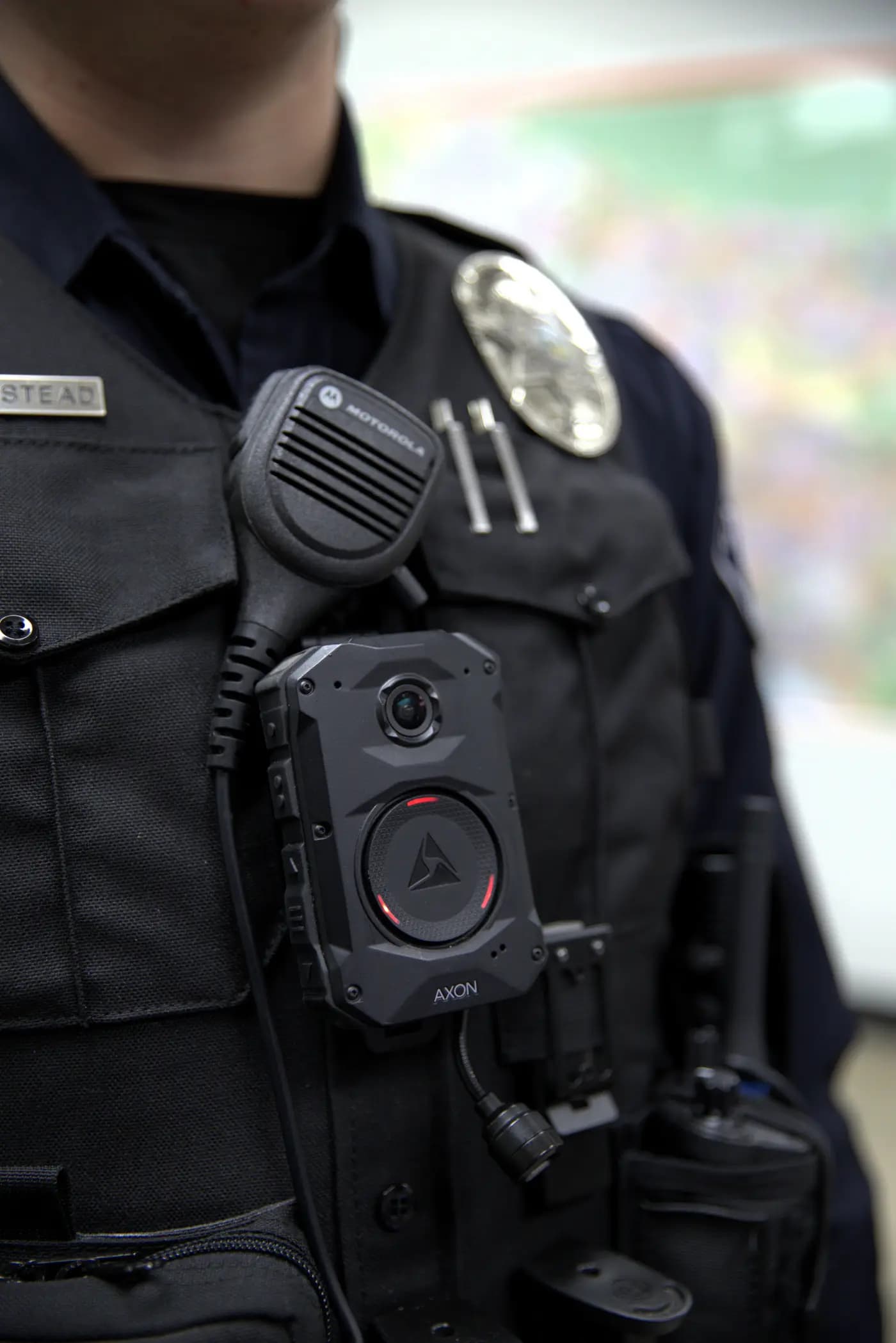 Axon body camera actively recording with red ring lit on an officer's vest