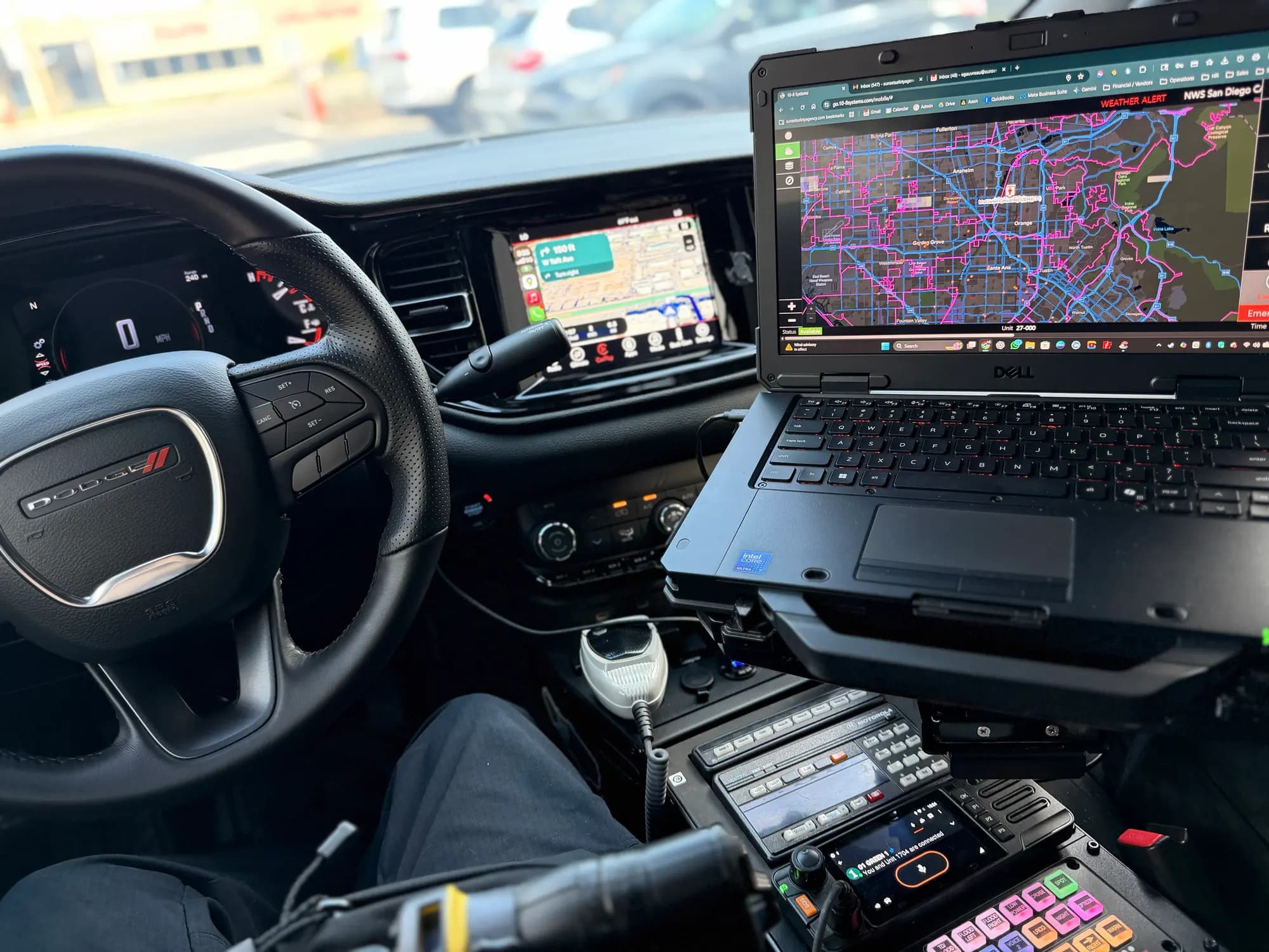In-car mobile data terminal running 10-8 Systems CAD dispatch in a patrol Durango