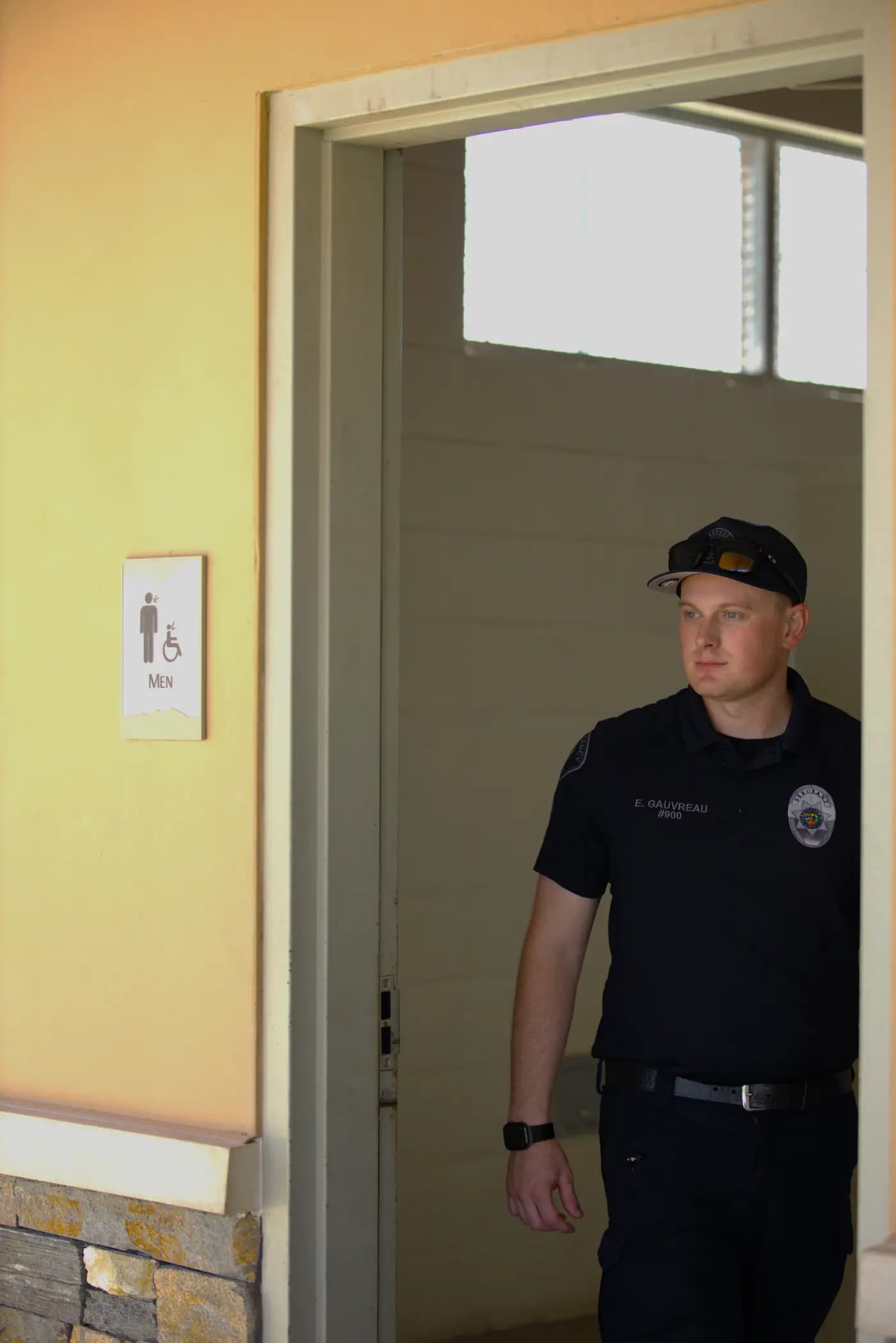 Sergeant stepping out of a campus facility during a routine check