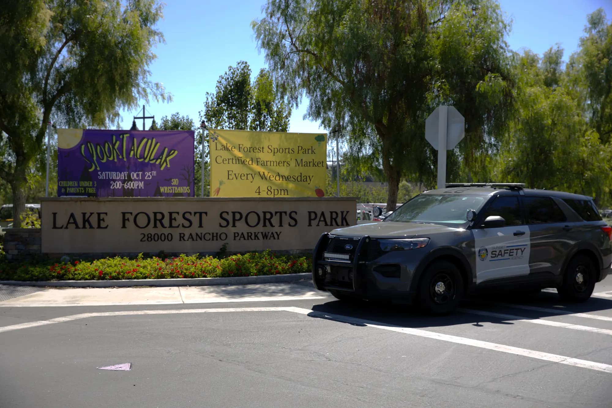 Marked patrol Explorer rolling past a community sports park monument sign