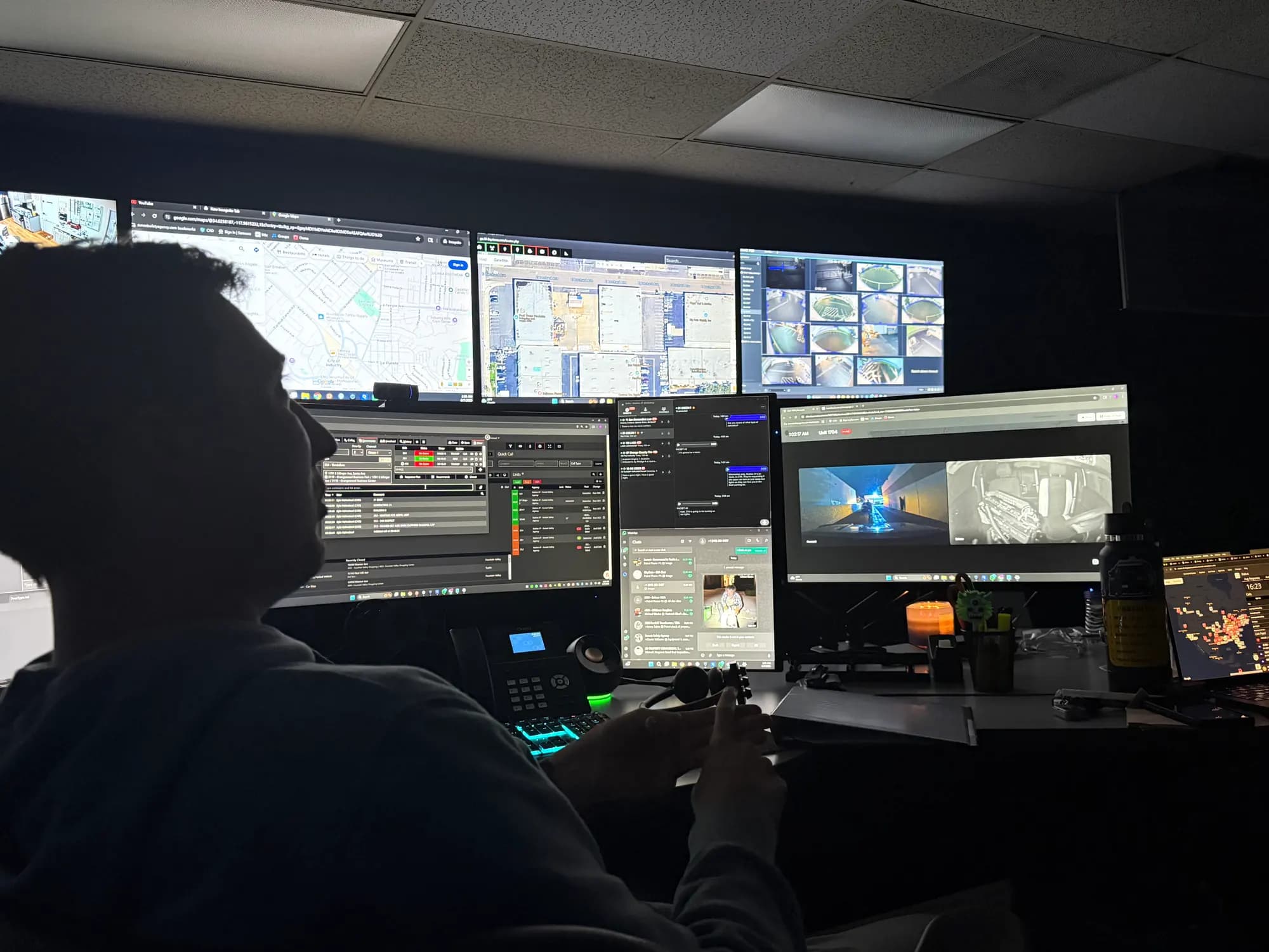 Sunset Safety Agency dispatcher at the 24/7 real-time information center monitor wall