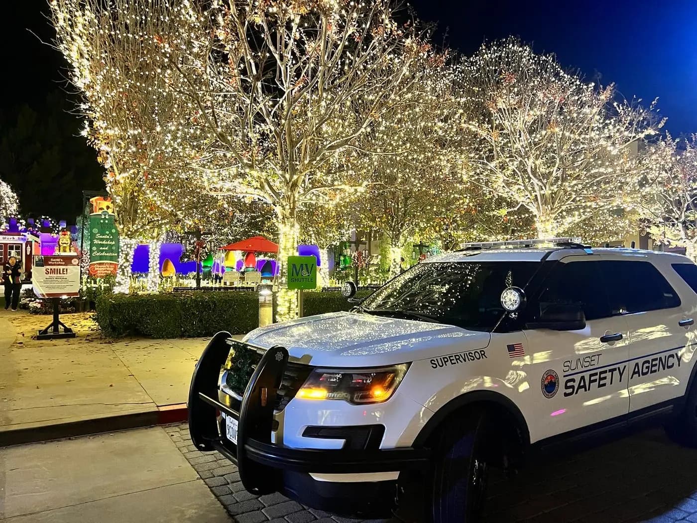 Supervisor patrol unit posted at a holiday-lights community event at night