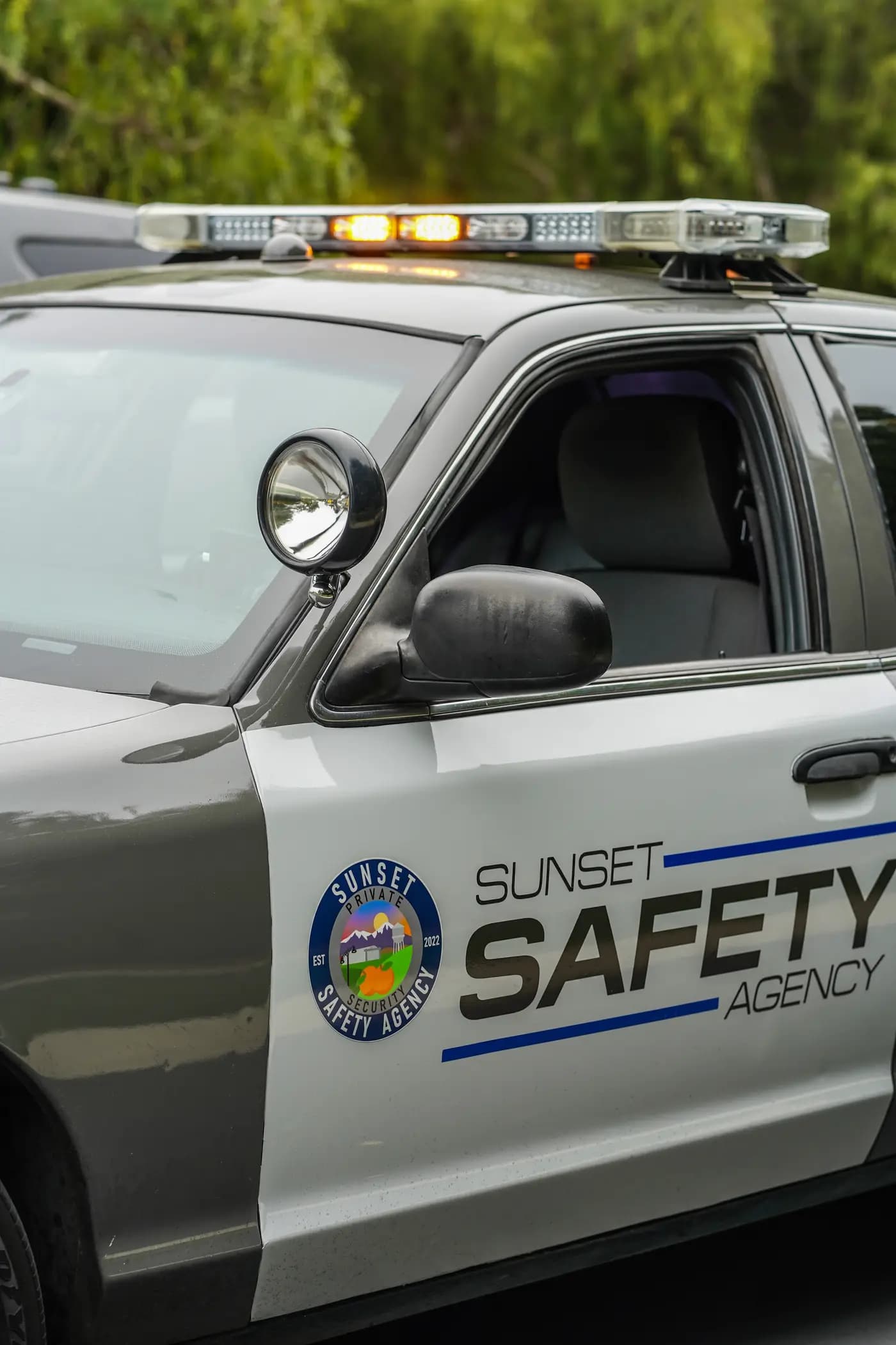 Sunset Safety Agency patrol car door seal with amber lightbar