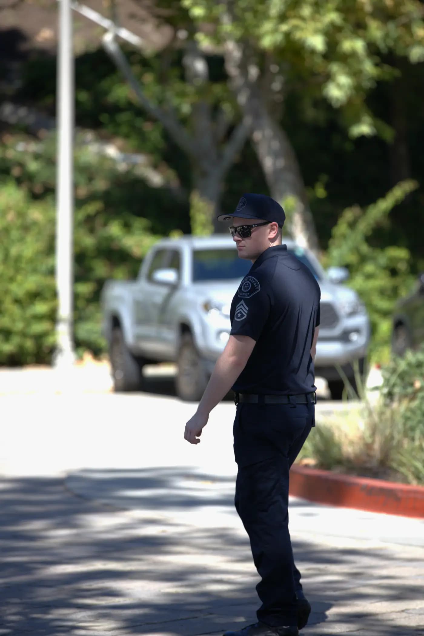 Officer walking a community parking area checking permits and violations