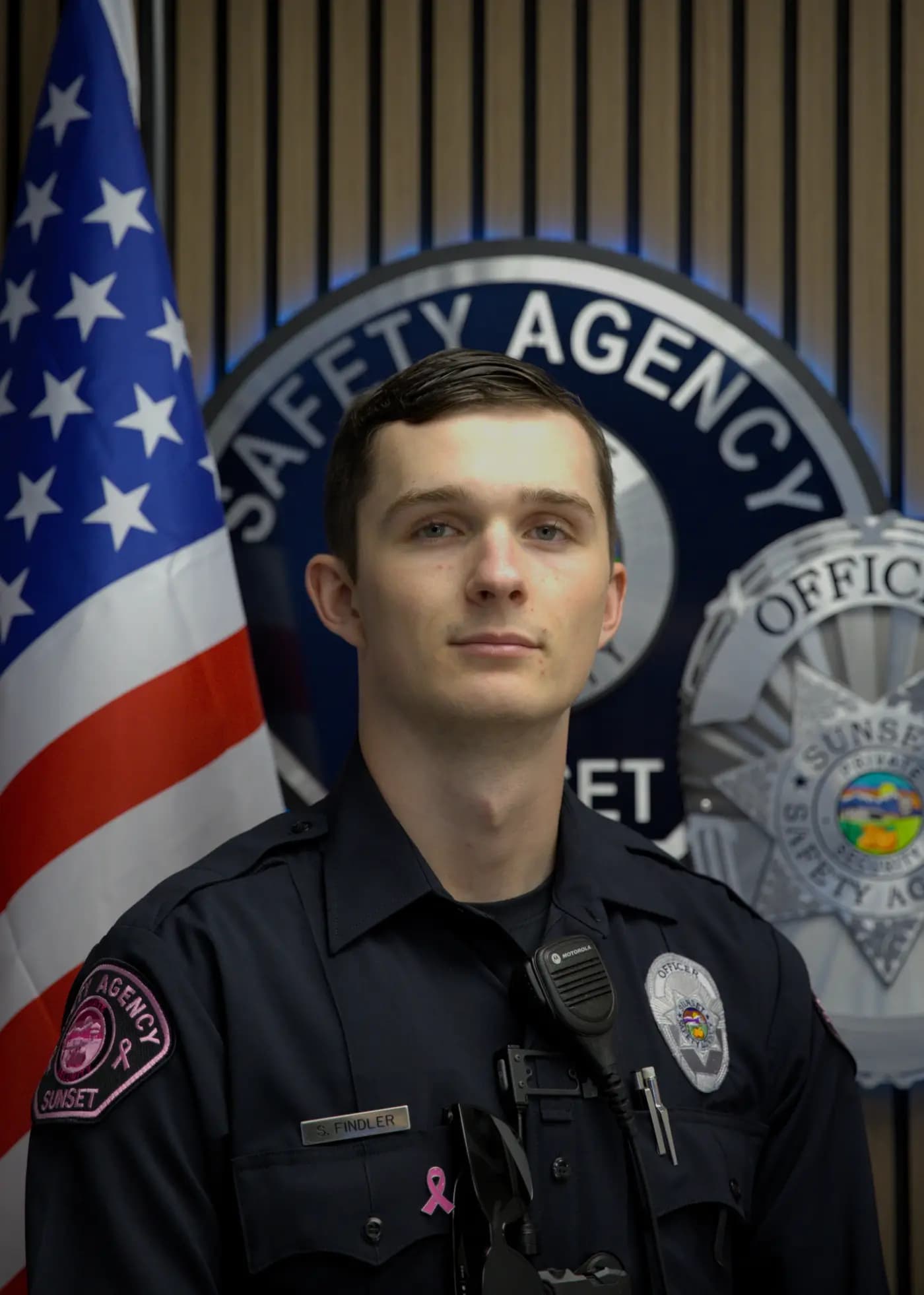 Close roster portrait of an officer with radio mic on shoulder