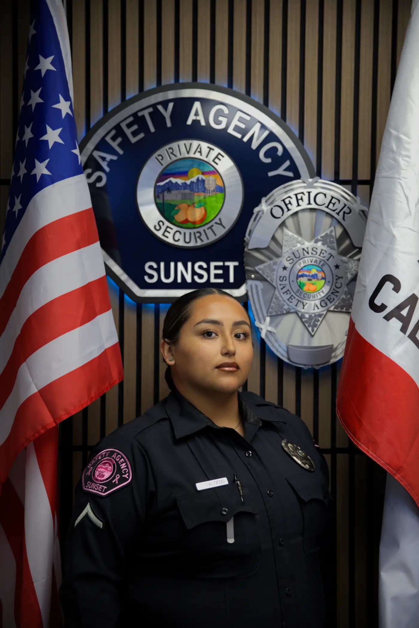 Studio roster portrait of an officer between the US and California flags