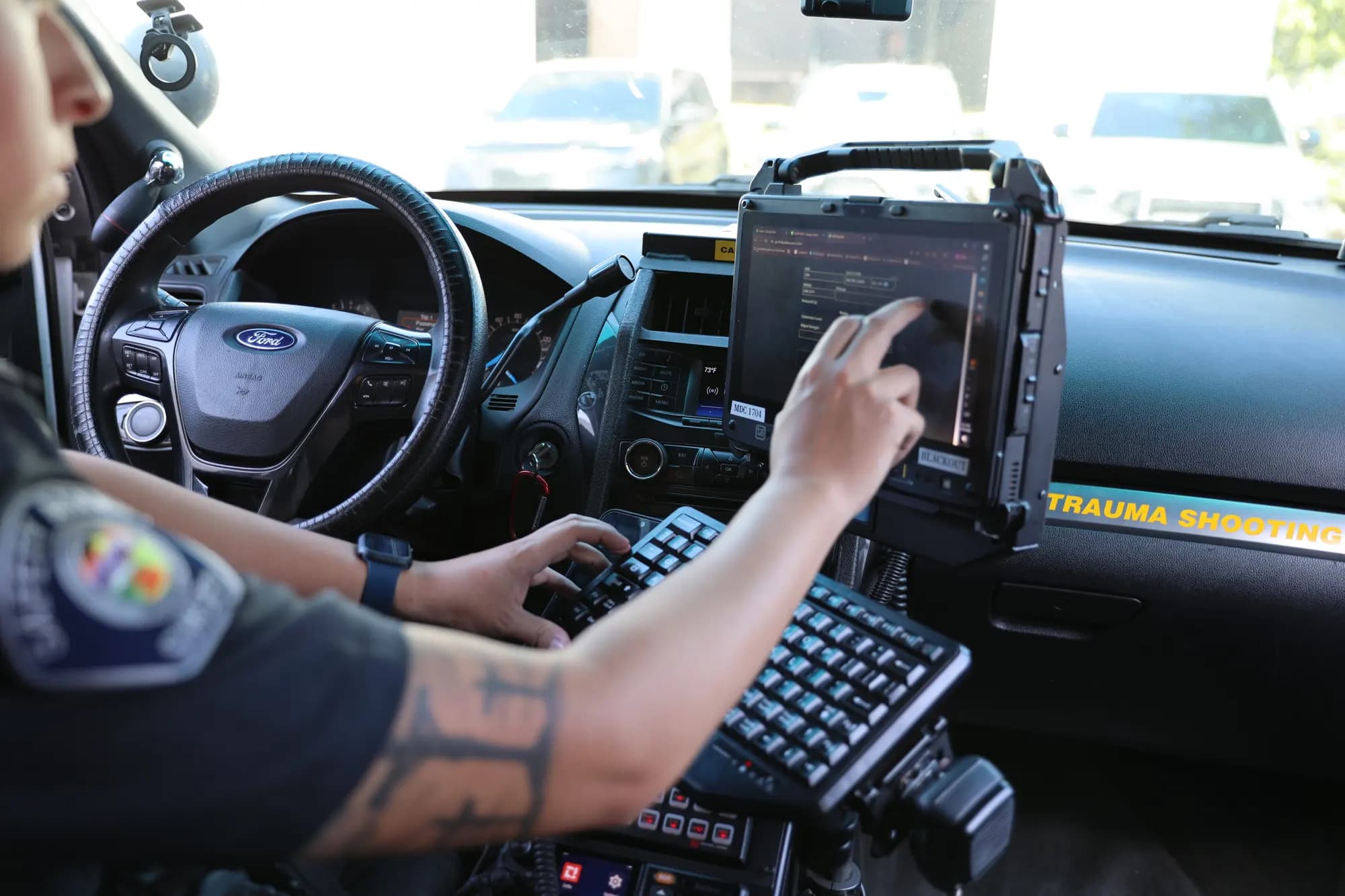 Officer checking the safe list on the in-car terminal during patrol