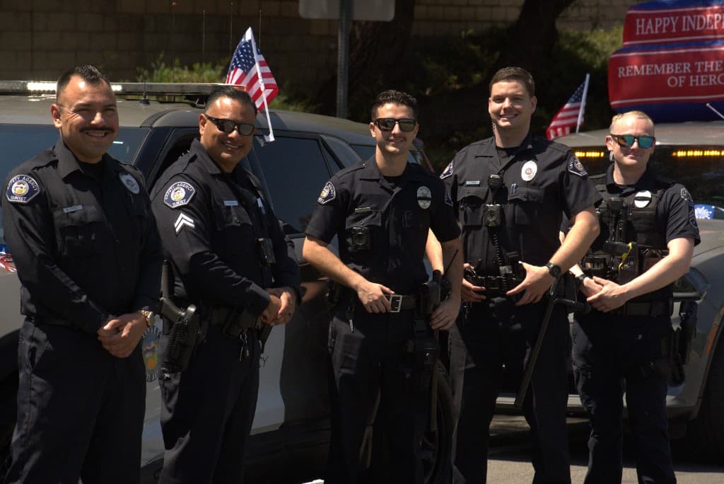 Sunset Safety Agency officer at a community parade with patrol vehicle