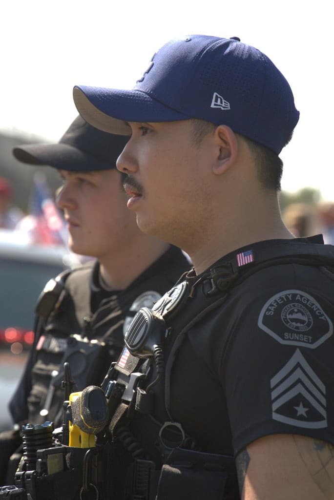 Five Sunset Safety Agency officers in front of decorated patrol vehicles