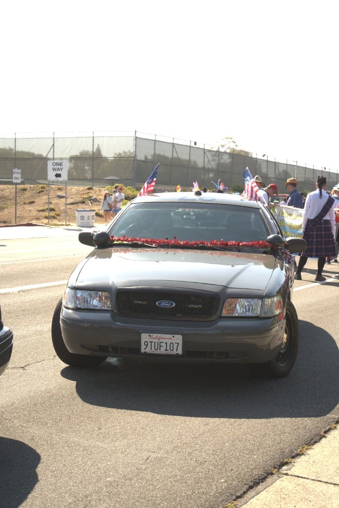 Line of Sunset Safety Agency patrol vehicles in a parade